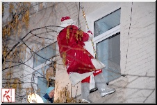 congratulating on New Year Santa claus from a roof